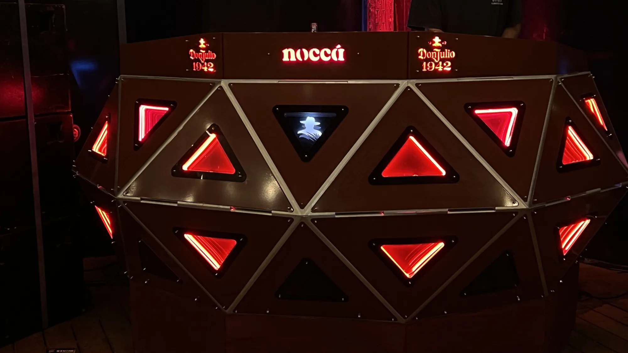 Tri Cular — A console you stand inside — a crescent of forty-eight lit triangular facets.
